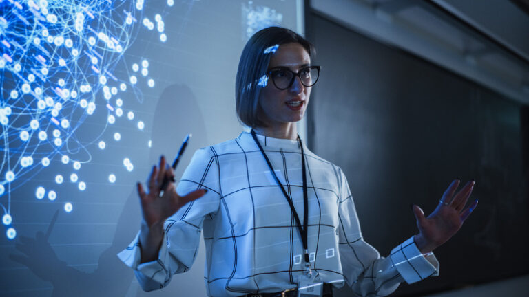 GettyImages-1516275128 county college of morris | woman standing in front of a projector with data science in the background