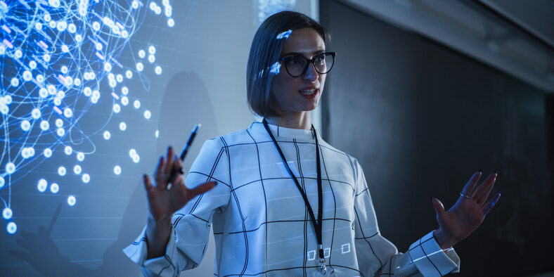 GettyImages-1516275128 county college of morris | woman standing in front of a projector with data science in the background